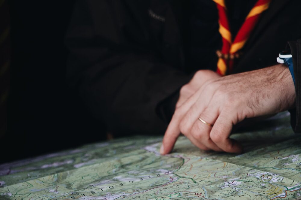 photo of man pointing on the map